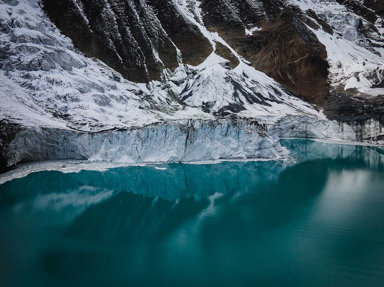 Tilicho glacier reflected in the turquoise water of Tilicho Lake