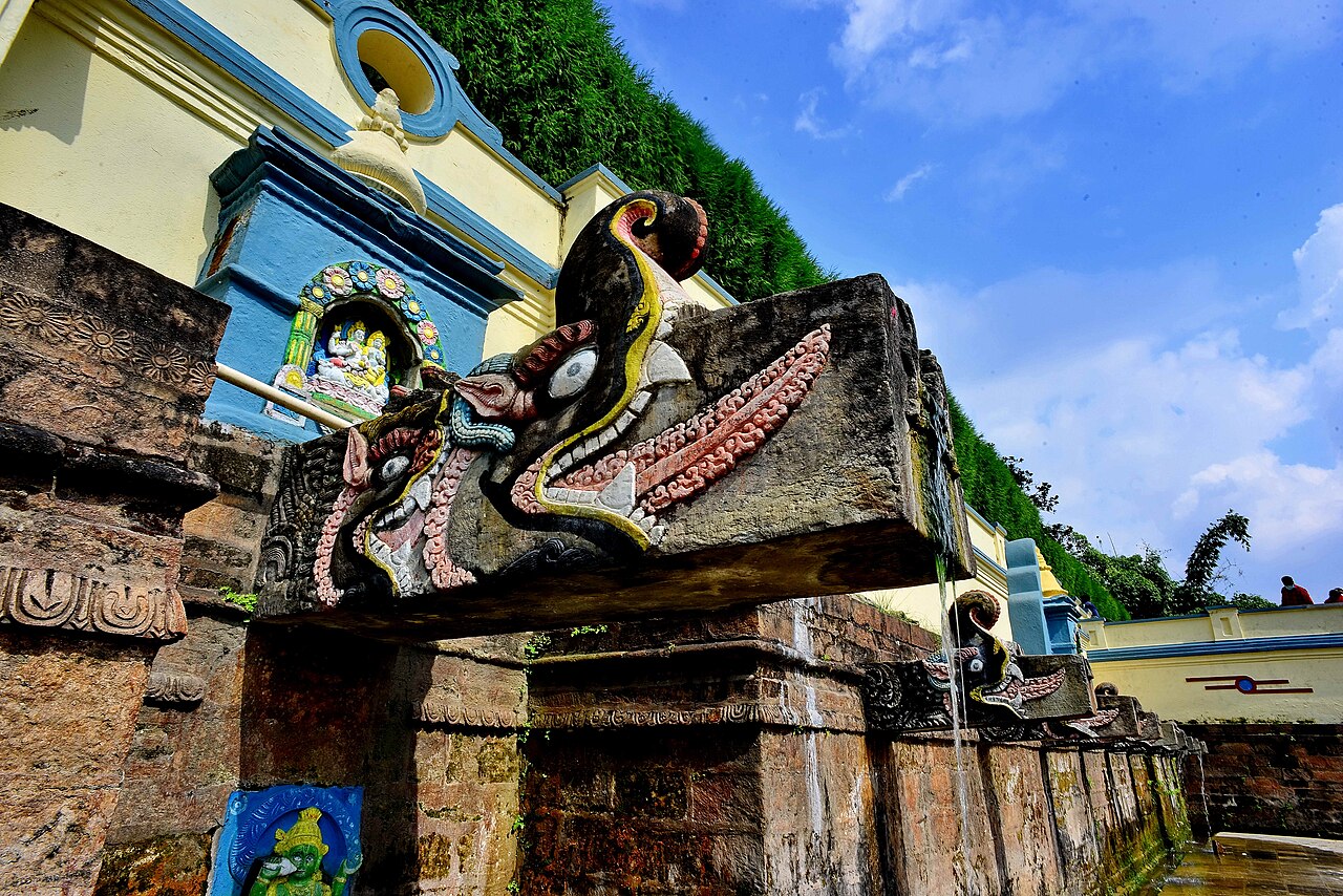 Carved stone spout and shrine details at Balaju Baisdhara